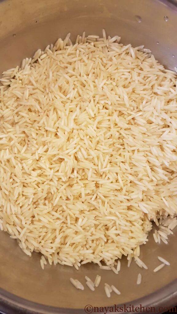 Draining the water from soaked rice