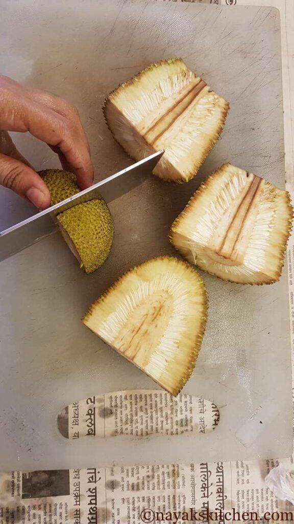 Cutting the quartered jackfruit further