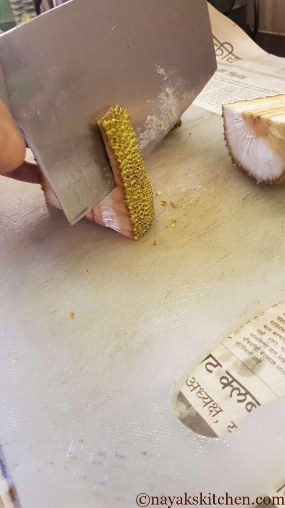Removing the outer rind of the jackfruit