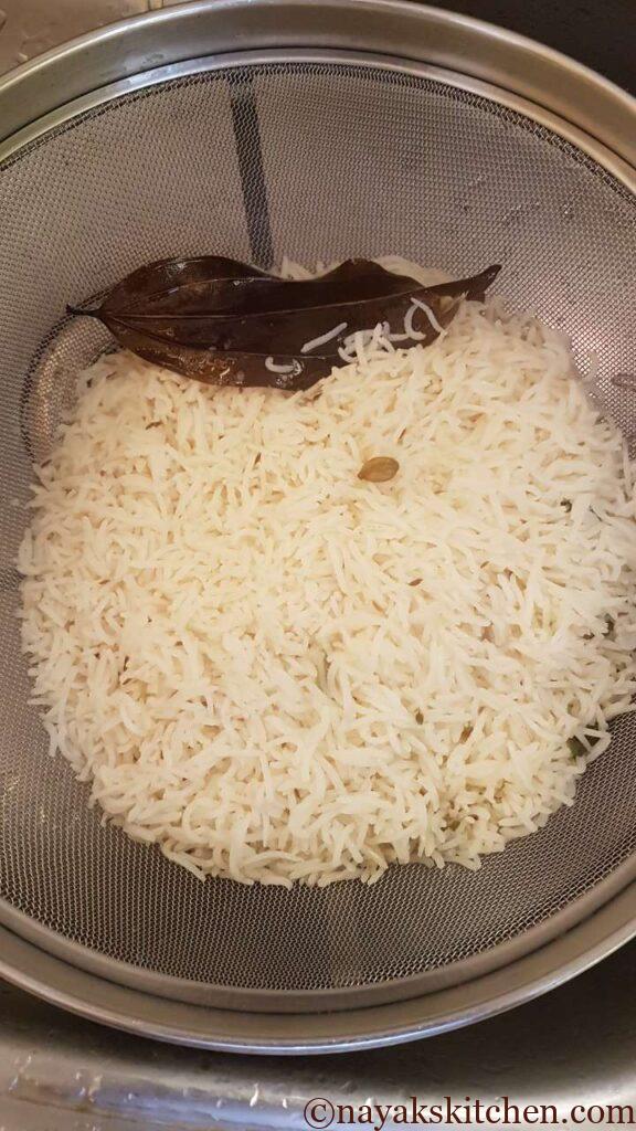 Straining rice in a colander