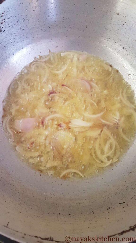 Adding sliced onions to hot oil
