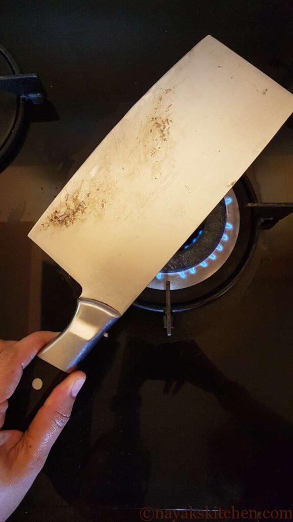 Warming the knife to clean the sap