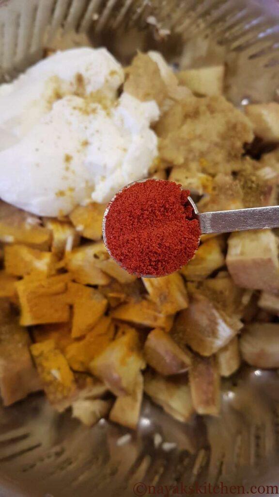 Adding chilli powder to jackfruit pieces