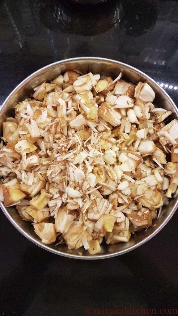 Adding raw jackfruit to a vessel