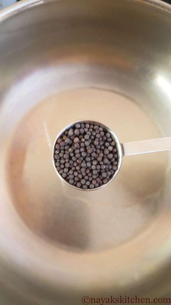 Adding mustard seeds to heated coconut oil