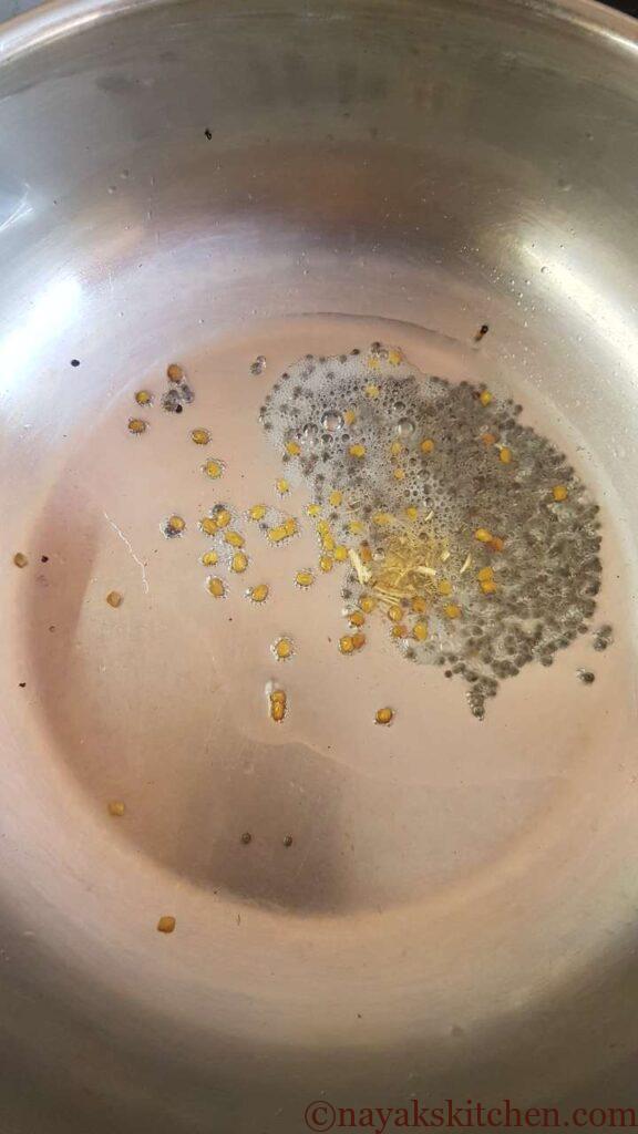 Mustard seeds, fenugreek seeds and hing in coconut oil