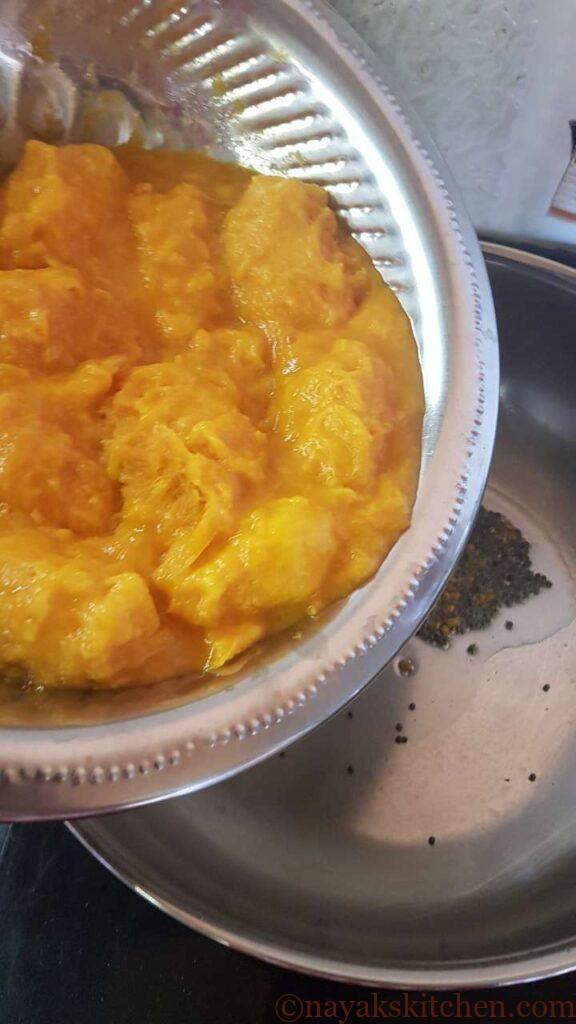 Adding small ripe mangoes with the pulp