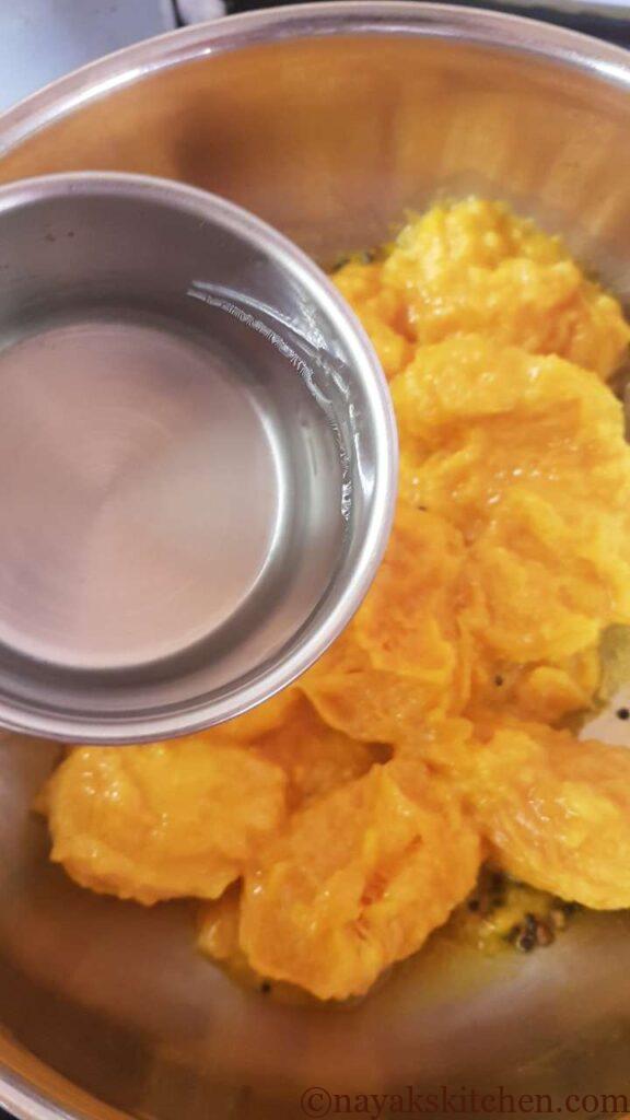 Adding water to steam the ripe mangoes