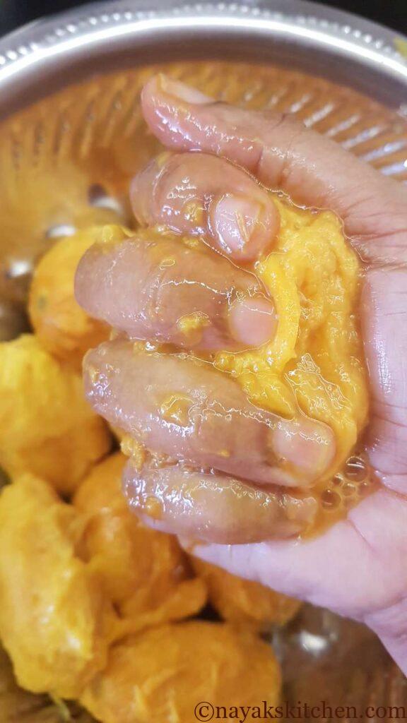Squeezing the mangoes to extract the pulp