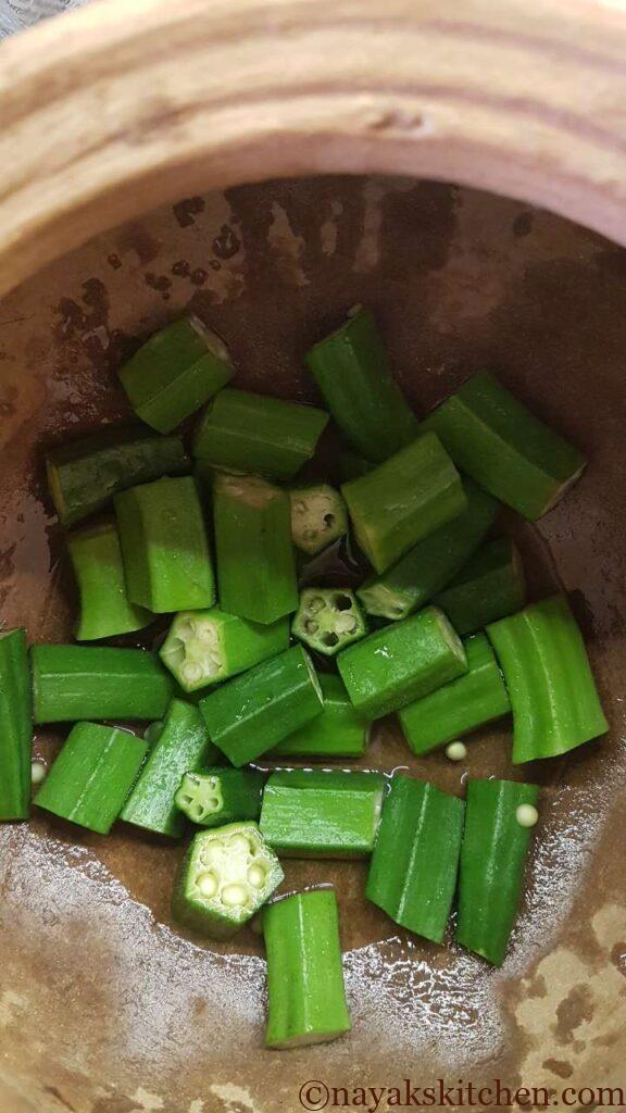 Chopped ladies finger in a mud pot