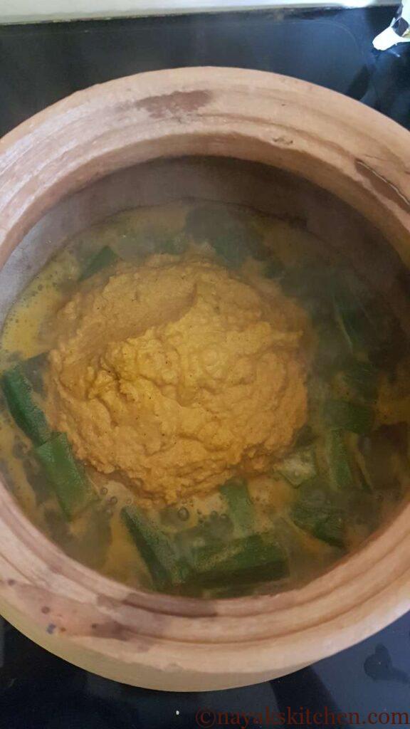 Adding ground coconut prawn curry paste